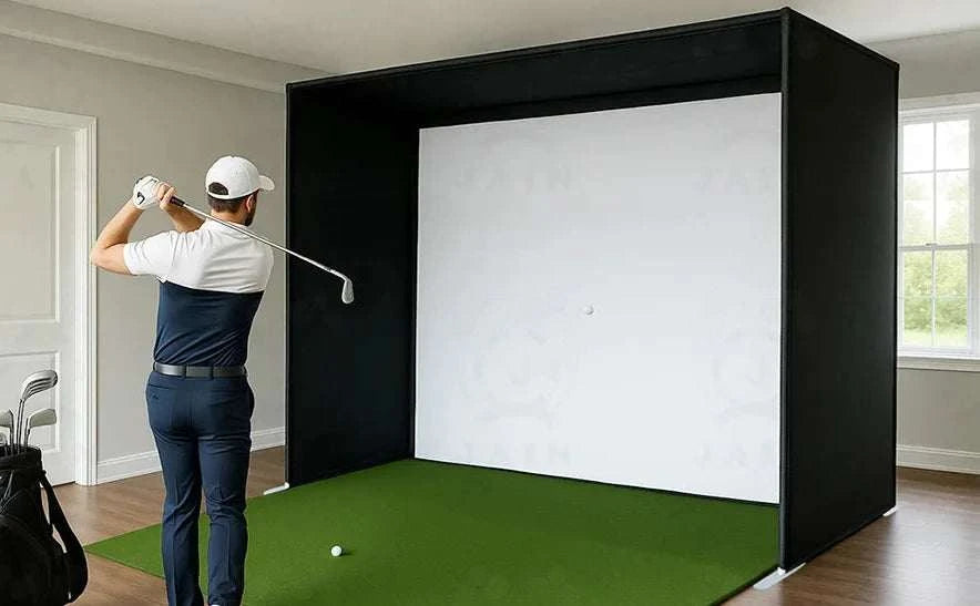 Golf Simulator Enclosure with a white impact screen, black side and top netting, and a green hitting surface
