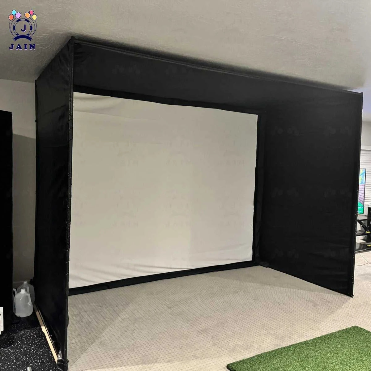 Golf Simulator Enclosure with a white impact screen, black frame, and full black side and top containment netting