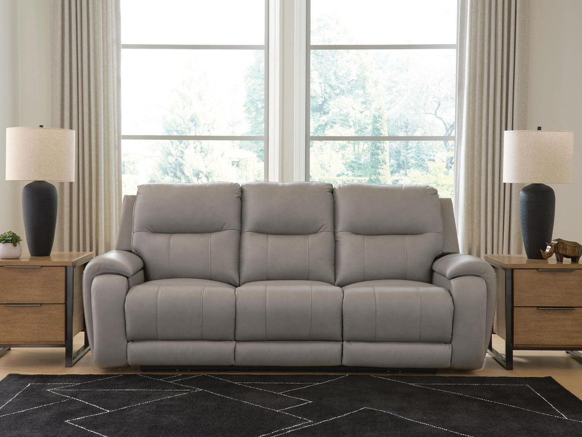 Real Moments power reclining sofa in ash gray leather with three cushioned seats, padded arms and adjustable headrests