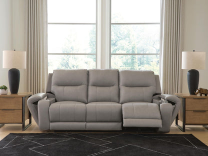 Real Moments power reclining sofa in ash gray upholstery with plush segmented cushions, padded arms, and extended footrest