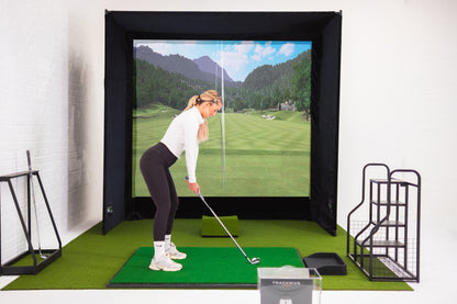 SimBox Golf Simulator Enclosure with a black frame, impact screen displaying a golf course, and green hitting mat