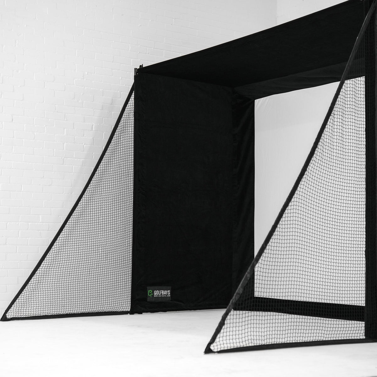 SimBox Golf Simulator Enclosure with a black fabric canopy, central impact screen and protective mesh side barriers